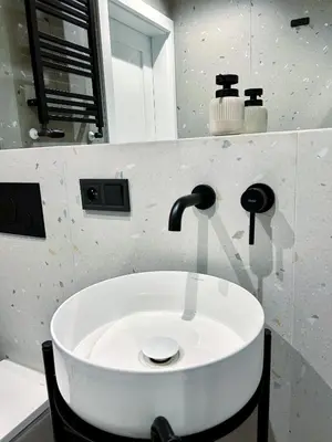 a white sink in a bathroom with a mirror at Composition 23 with blue circle in Kraków