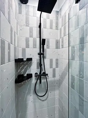 a shower with a shower head in a bathroom at Composition 23 with blue circle in Kraków