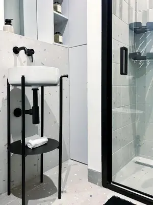 a bathroom with a sink and a shower at Composition 23 with blue circle in Kraków