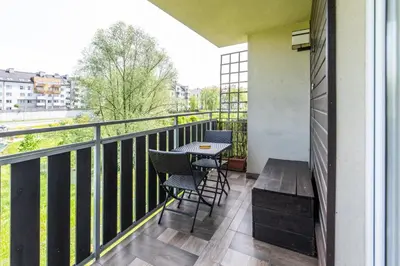 a balcony with a table and chairs and a view at LARGE LUXURY APARTMENT WIELICZKA in Wieliczka