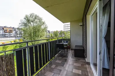 a balcony with a table and chairs on it at LARGE LUXURY APARTMENT WIELICZKA in Wieliczka