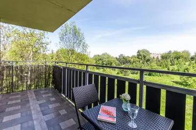 a table and chairs on a balcony with a view at LARGE LUXURY APARTMENT WIELICZKA in Wieliczka