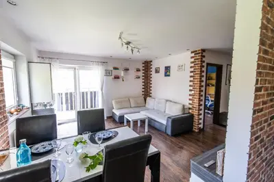 a living room with a table and a couch at LARGE LUXURY APARTMENT WIELICZKA in Wieliczka