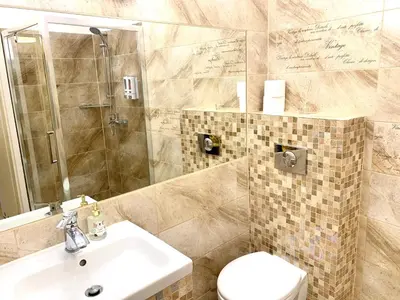 a bathroom with a sink and a toilet and a mirror at Apartament S19 in Kraków
