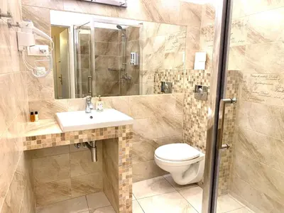 a bathroom with a toilet and a sink and a shower at Apartament S19 in Kraków