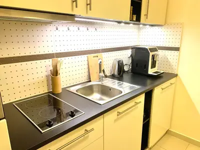 a kitchen counter with a sink and a microwave at Apartament S19 in Kraków