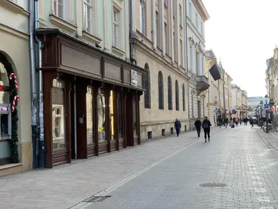 a city street with people walking down the street at Apartament S19 in Kraków