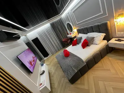 a small bedroom with a bed with red pillows at Paris in Cracow Apartment in Kraków