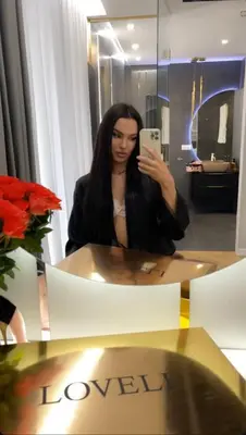 a woman taking a picture of herself in a mirror at Paris in Cracow Apartment in Kraków