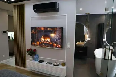 a living room with a fireplace in the wall at Paris in Cracow Apartment in Kraków