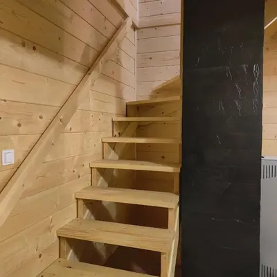 a staircase in a house with wooden walls at beskid.house1 in Spytkowice