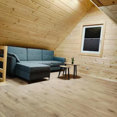 a living room with a blue couch and a table at beskid.house1 in Spytkowice
