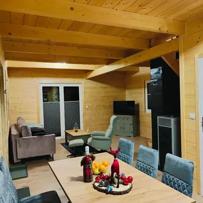 a living room with a table and chairs at beskid.house1 in Spytkowice