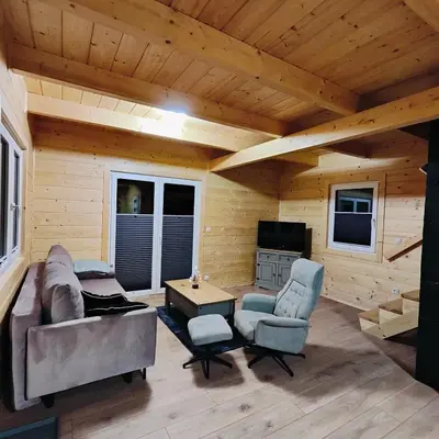 a living room with a couch and chairs and a tv at beskid.house1 in Spytkowice