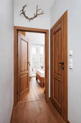 a hallway with an open door and a bedroom at Luminous Loft - Modern Old Town Apartment - by Upstairs in Kraków