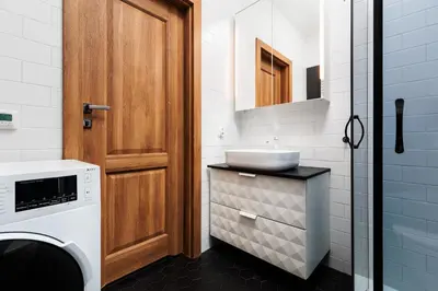 a bathroom with a sink and a washing machine at Luminous Loft - Modern Old Town Apartment - by Upstairs in Kraków