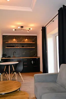 a living room with a couch and a table at Leśna Muzyka Apartment Limanowa in Limanowa