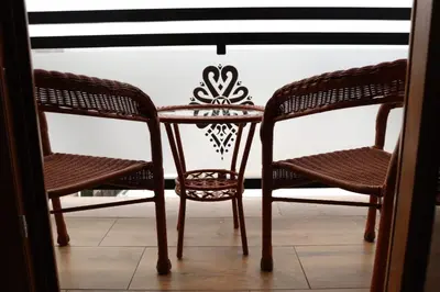 a table and two chairs and a table and chairs at Domek Parzenica Nowy Targ in Nowy Targ