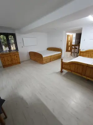 a large room with two beds and a window at Agroturystyka Rudy Kocur Różana 24 Jaroszowice in Jaroszowice