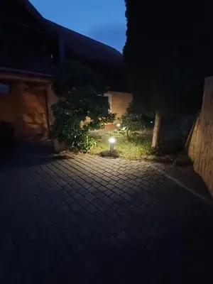 a light in the yard of a house at night at Agroturystyka Rudy Kocur Różana 24 Jaroszowice in Jaroszowice