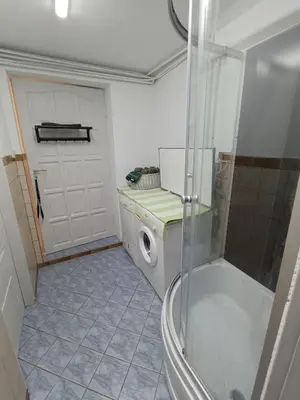 a bathroom with a shower and a washing machine at Agroturystyka Rudy Kocur Różana 24 Jaroszowice in Jaroszowice
