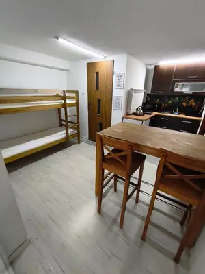 a room with a table and a bunk bed at Agroturystyka Rudy Kocur Różana 24 Jaroszowice in Jaroszowice
