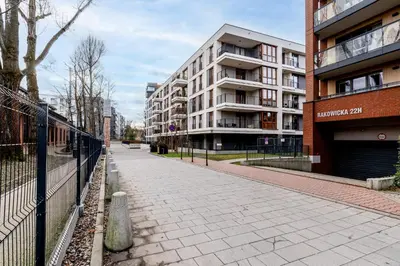 an empty sidewalk in front of a building at Cracow Novum Apartment #58 by BookingHost in Kraków
