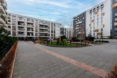 an empty street in a city with tall buildings at Cracow Novum Apartment #58 by BookingHost in Kraków