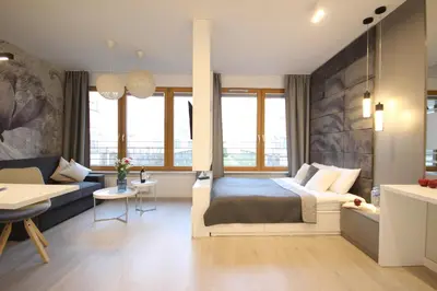 a bedroom with a bed and a couch at VIVA LILA Apartment, FREE PARKING, close to Vistula River - by Homelike Krakow in Kraków