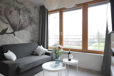 a living room with a couch and two tables at VIVA LILA Apartment, FREE PARKING, close to Vistula River - by Homelike Krakow in Kraków