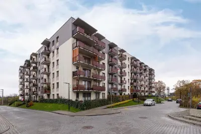 a large apartment building on the side of a street at Near EXPO Cracow Elegant Apartment by Noclegi Renters in Kraków