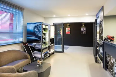 a living room with a couch and a window at Automobil Hotel in Kraków