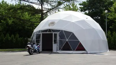 a tent with a motorcycle parked in front of it at Automobil Hotel in Kraków