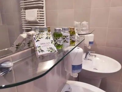 a bathroom with a sink and a glass counter top at Automobil Hotel in Kraków