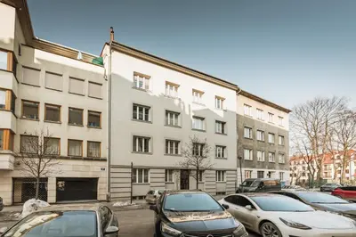 a parking lot with cars parked in front of a building at Skawinska Suites by Fragola Apartments in Kraków