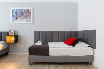 a bedroom with a large bed with a red pillow at Wonderful Apartments in the Center of Krakow in Kraków