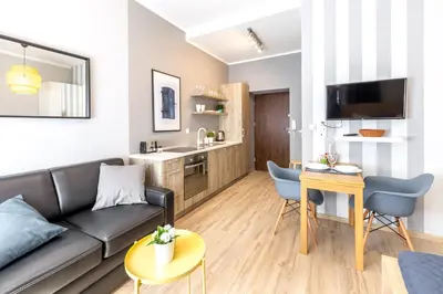 a living room with a couch and a table at Wonderful Apartments in the Center of Krakow in Kraków