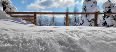 a pile of snow in front of a fence at Chatka Beatki in Stryszawa