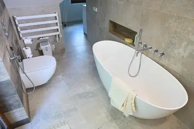 a bathroom with a bath tub and a toilet at Chatka Beatki in Stryszawa