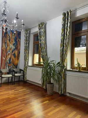 a living room with a potted plant and a painting at Apartament w centrum Brzeska 1 in Brzesko