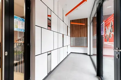 an empty hallway of a building with glass doors at Tauron Modern Studio by BookingHost in Kraków