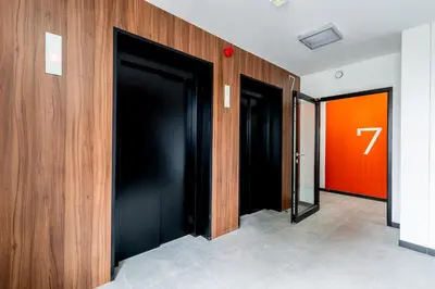 a row of elevators in a building with a z sign at Tauron Modern Studio by BookingHost in Kraków