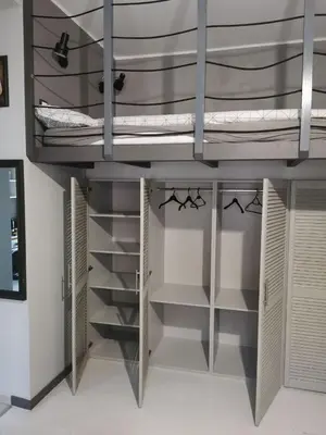 a room with a bunk bed with shelves at Komfort w sercu Kazimierza in Kraków