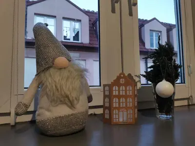 a stuffed animal sitting on a table next to a window at Komfort w sercu Kazimierza in Kraków