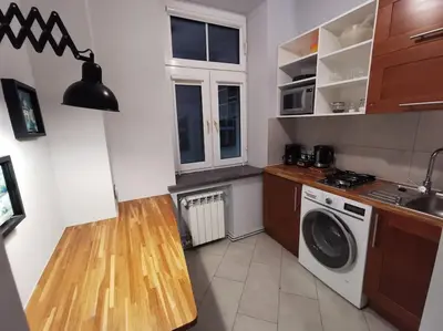 a kitchen with a washer and a washing machine at Komfort w sercu Kazimierza in Kraków