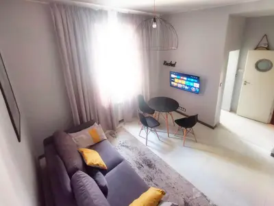 a living room with a couch and a table at Komfort w sercu Kazimierza in Kraków