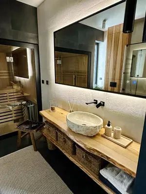 a bathroom with a sink and a large mirror at BM Apartments - parter domu z tarasem in Kraków