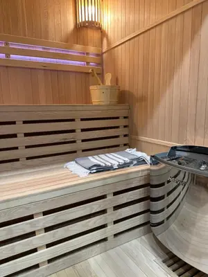 a sauna with a bench in a wooden room at BM Apartments - parter domu z tarasem in Kraków
