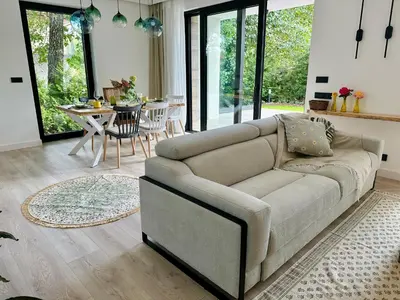 a living room with a couch and a table at BM Apartments - parter domu z tarasem in Kraków