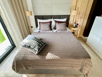 a bedroom with a large bed with pillows at BM Apartments - parter domu z tarasem in Kraków